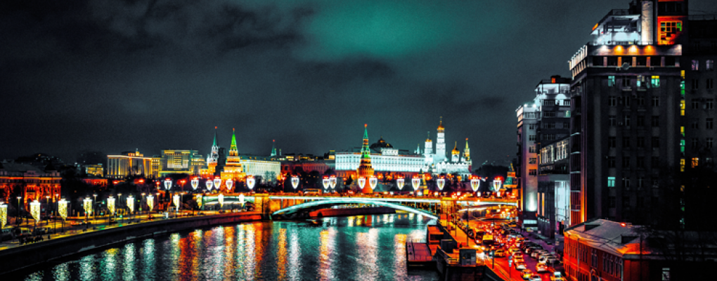 Night time view of a Moscow canal - the lights emitted from the buildings reflecting off the water